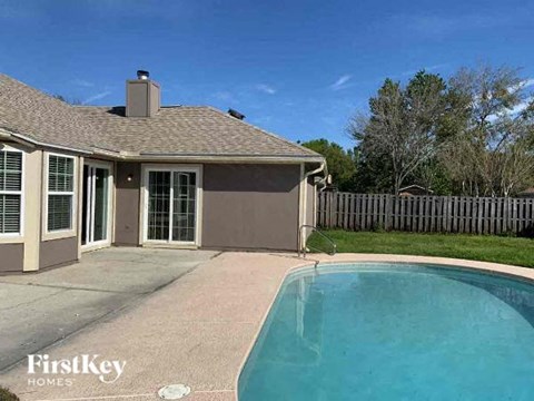 a swimming pool in front of a house
