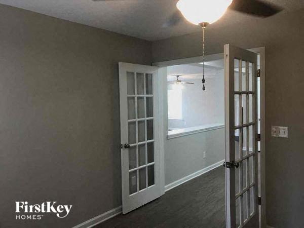 a empty room with a door and a window