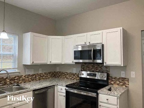 a kitchen with a stove and a microwave