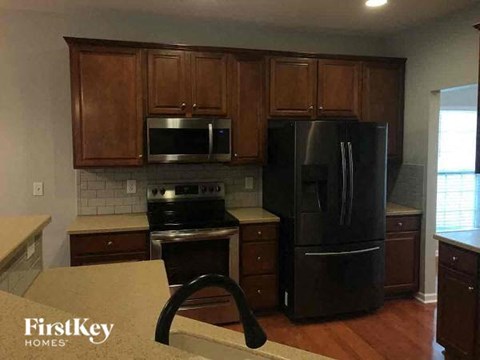 a kitchen with black appliances and wooden cabinets