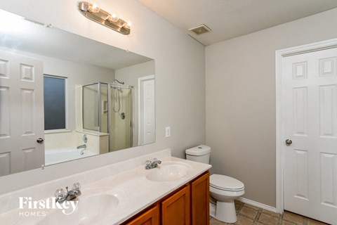 a bathroom with a sink toilet and a mirror
