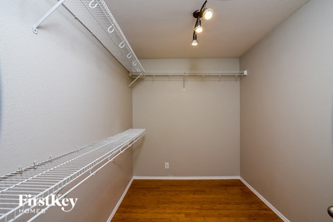 an empty room with a closet and a wood floor