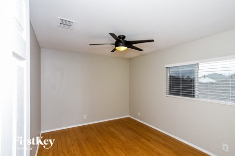 a living room with a ceiling fan and a window