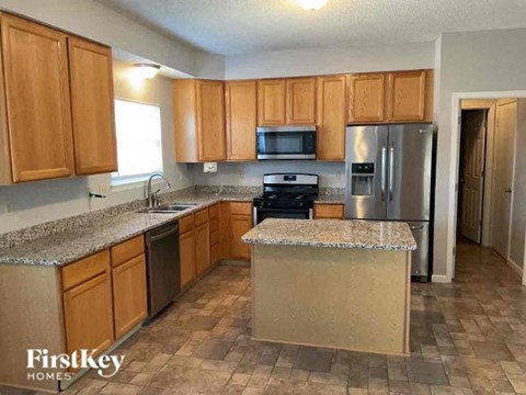 a kitchen with stainless steel appliances and granite counter tops