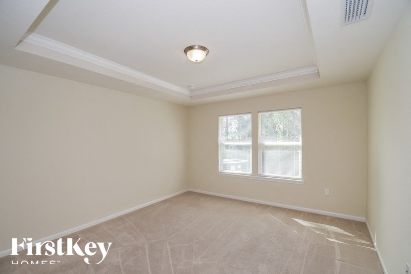 A room with a FirstKey Homes logo on the bottom left corner.