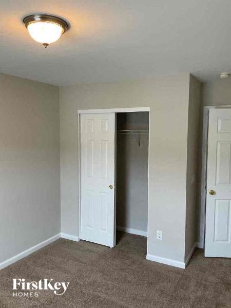an empty room with a closet and an open door