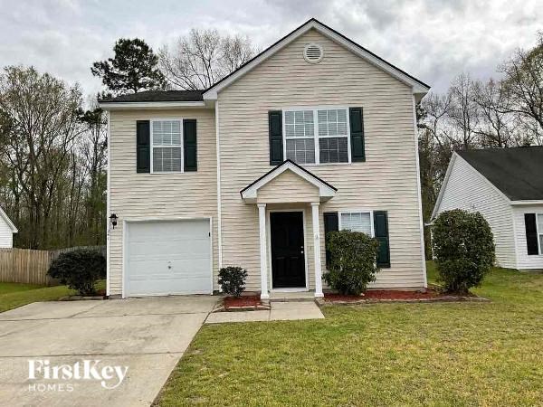 a white house with black shutters and a white garage