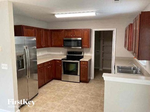 a kitchen with stainless steel appliances and wooden cabinets