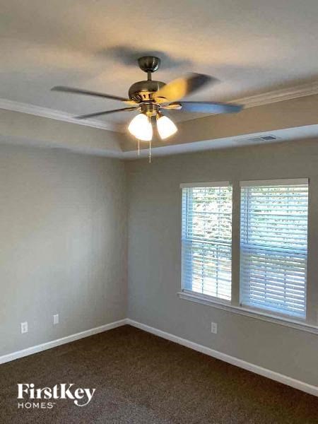 an empty room with a ceiling fan and a window