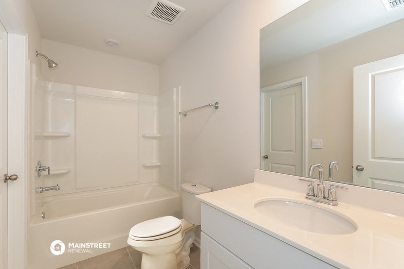 a bathroom with a sink toilet and a shower