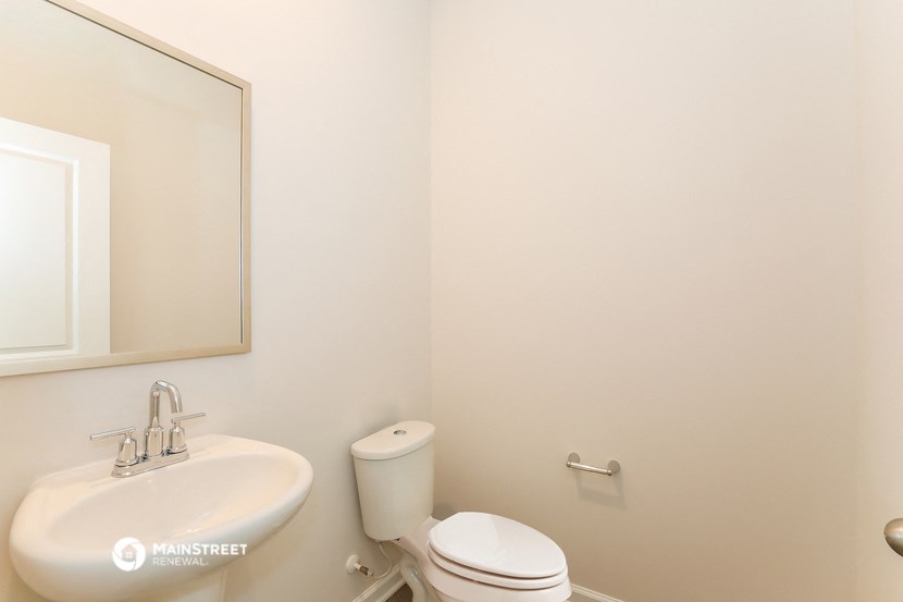 a bathroom with a sink and a toilet and a mirror