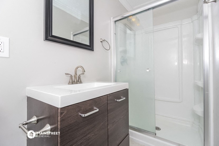 a small bathroom with a sink and a shower