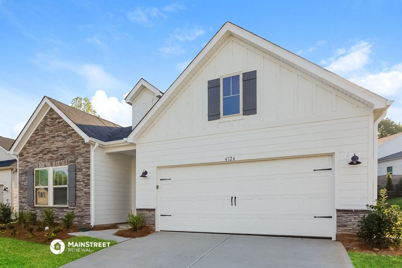 a white garage door in front of a house