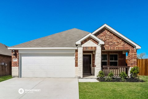 a brick house with a garage door in front of it