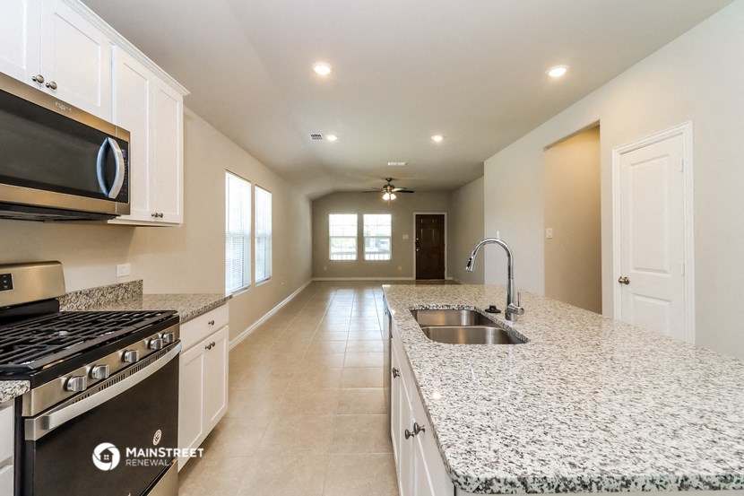 a kitchen with granite counter tops and a sink and a stove
