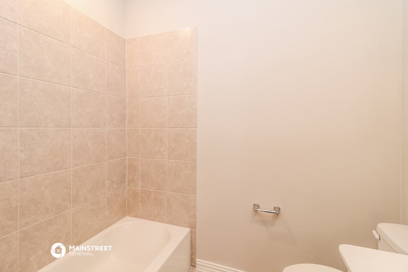 a bathroom with a toilet and a tub and a sink