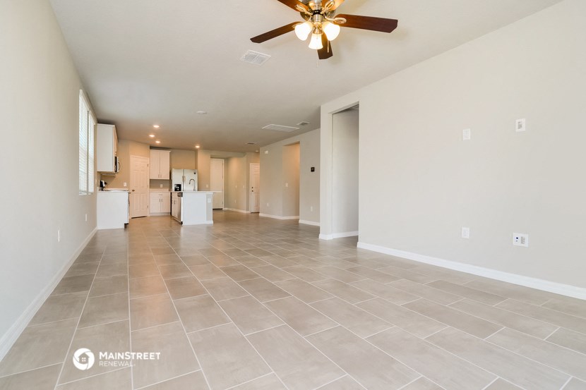 the living room and kitchen are spacious and clean with tile flooring
