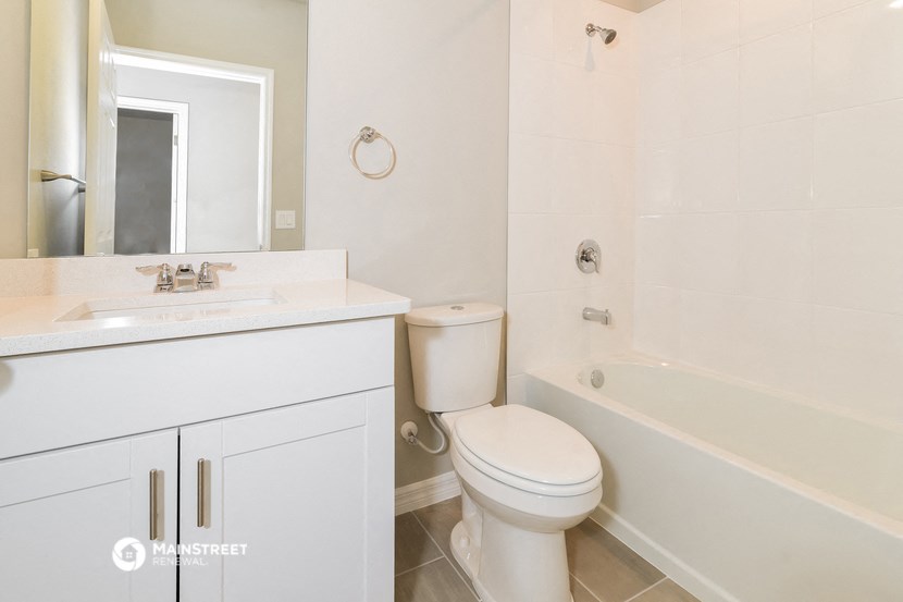a bathroom with a toilet and a tub and a sink