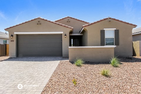 the front of a house with a driveway and a garage door