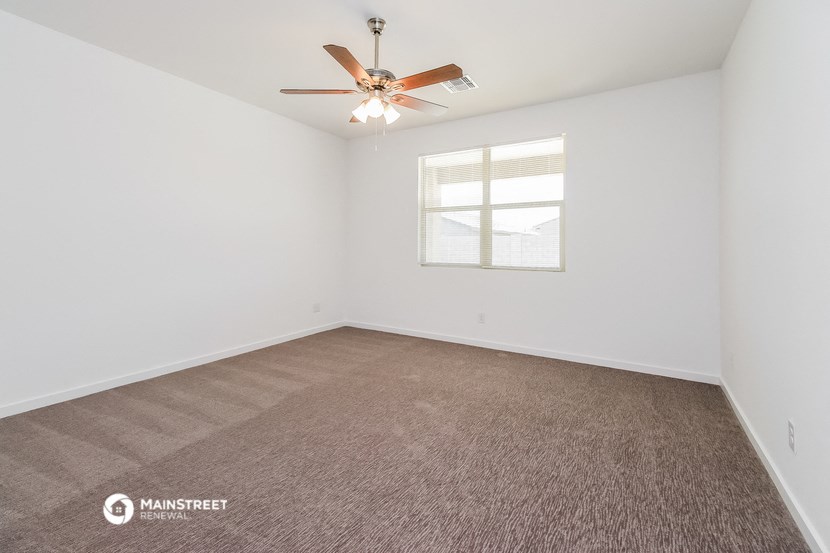 a living room with a ceiling fan and a window