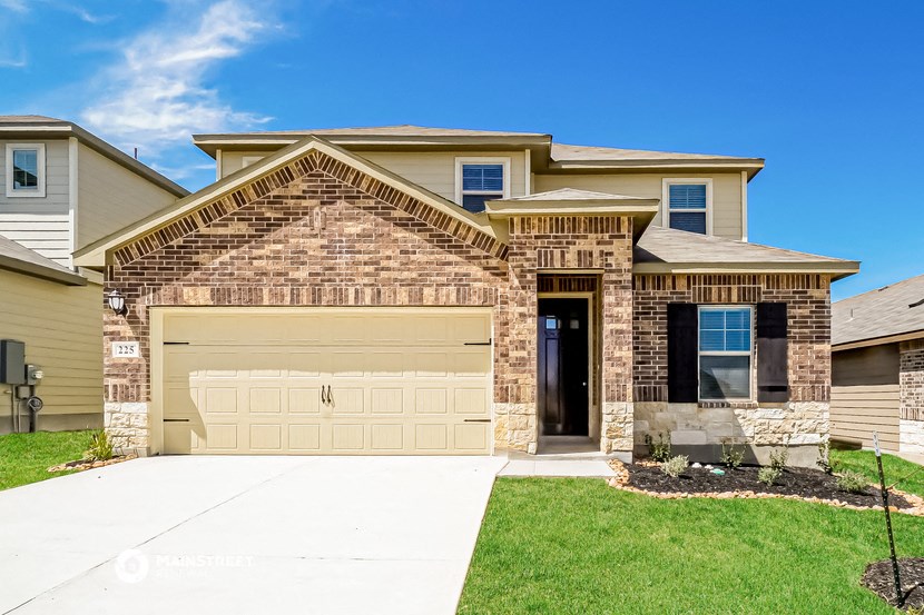 a tan house with a garage door in front of it