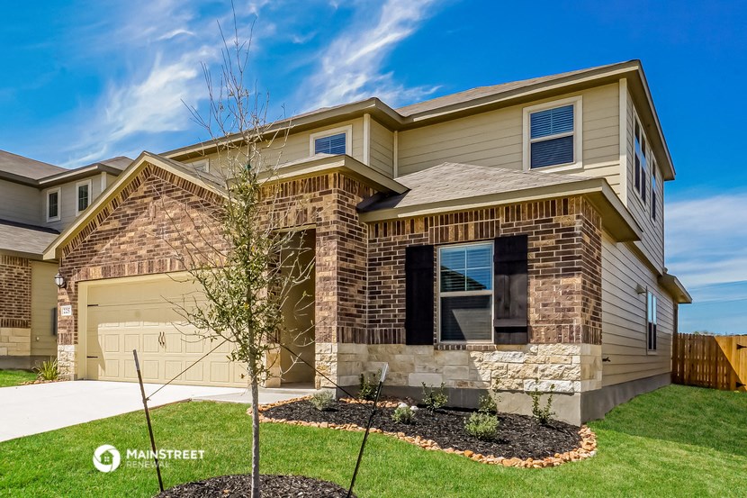 a tan and brown house with a garage