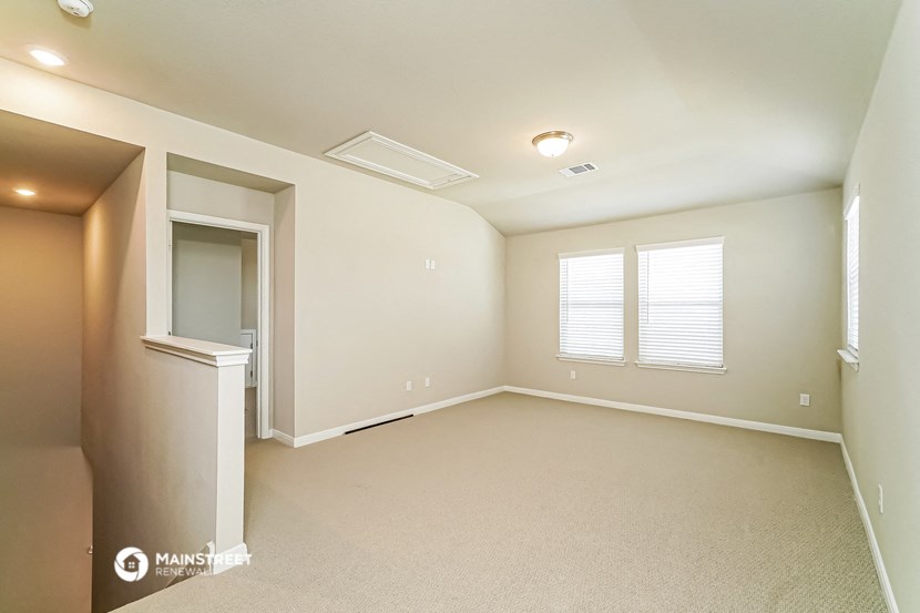 an empty living room with a closet and a window
