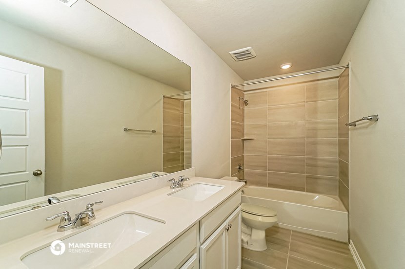 a bathroom with a sink and a toilet and a shower