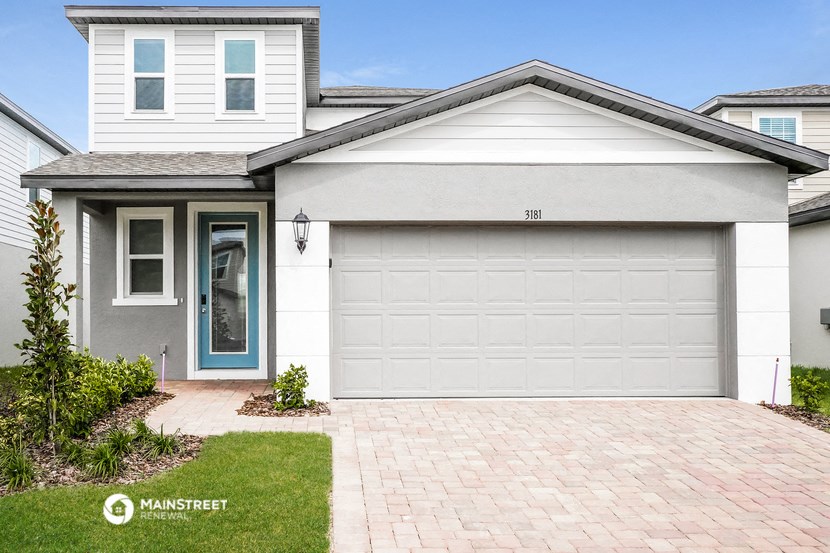 a white garage door in front of a house