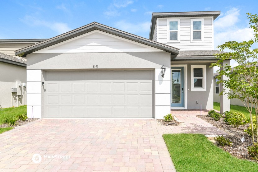 a white garage door in front of a house