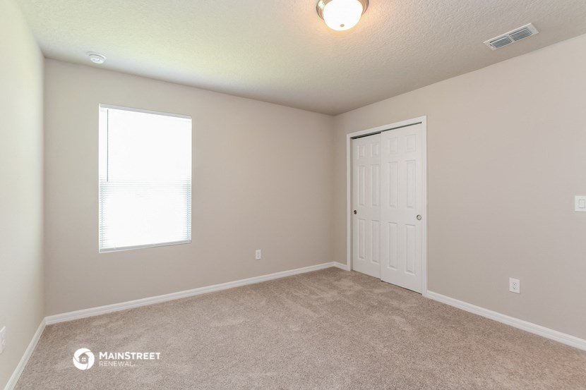the upstairs bedroom has a door to the closet and a window