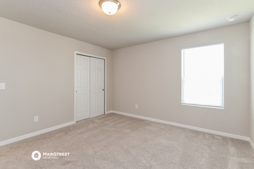 the spacious living room of a manufactured home with a window and a door