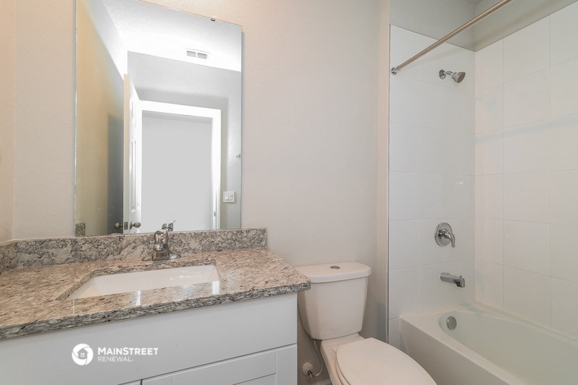 a bathroom with a sink and a toilet and a shower