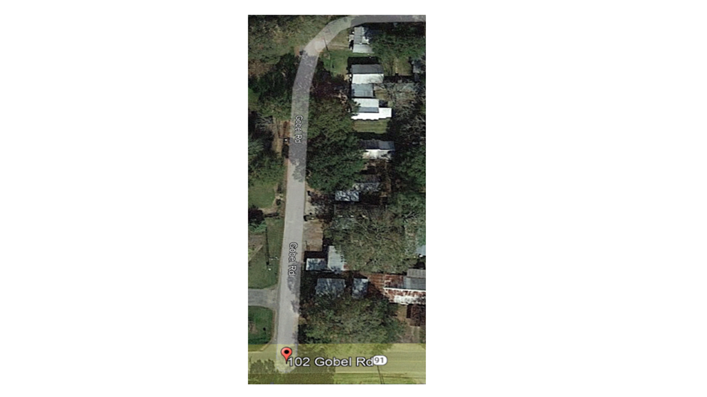 an aerial view of a road with cars and trees