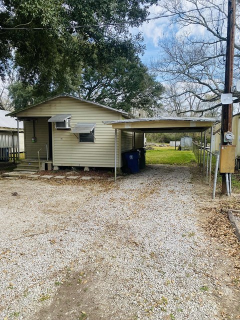a small house with a dirt road in front of it