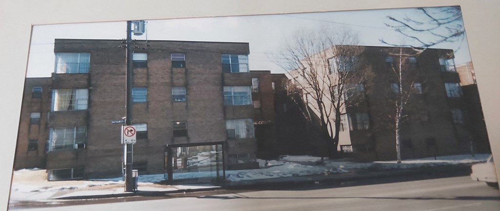 a painting of a brick building on a city street