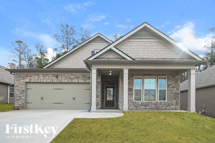 a house with a garage door and a lawn