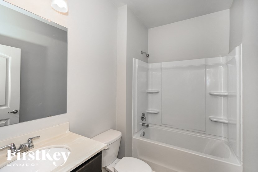 a bathroom with a sink toilet and a bath tub