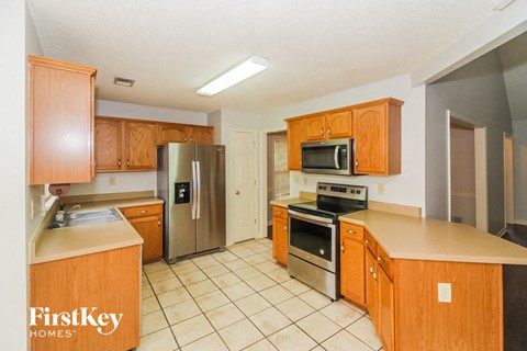 a kitchen with wooden cabinets and stainless steel appliances