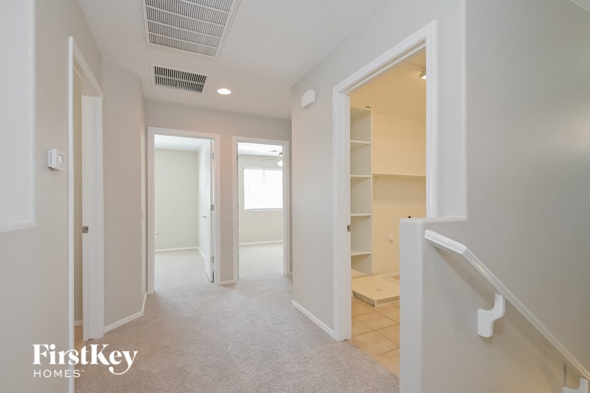 A white hallway with a FirstKey Homes logo.