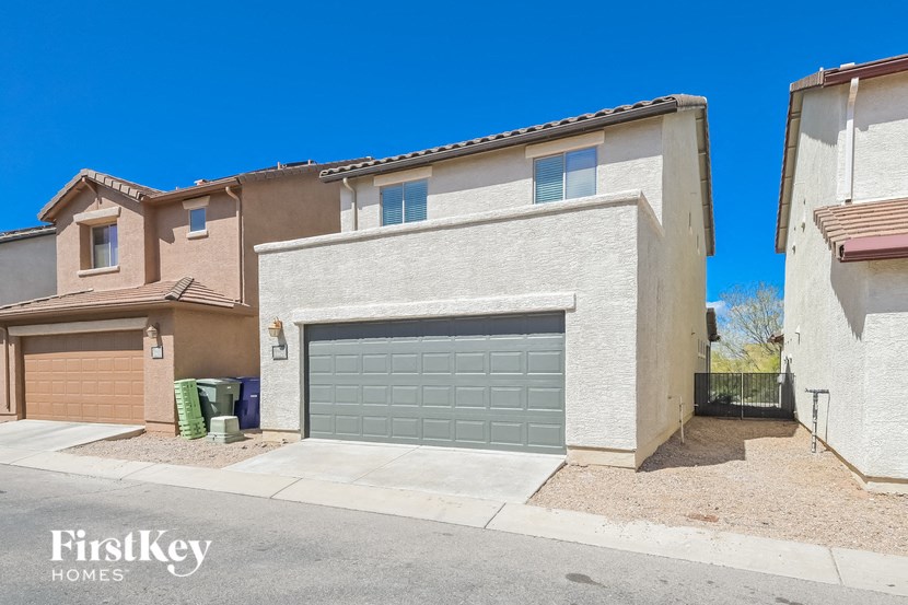 A house with a garage door is for sale by FirstKey Homes.