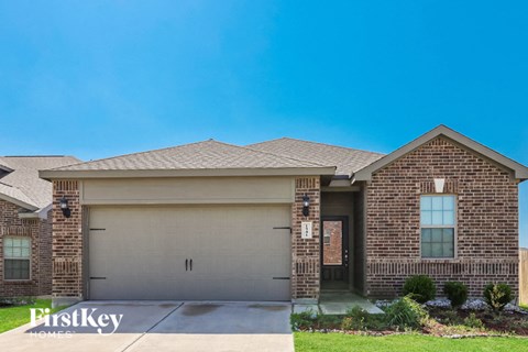 a home with a garage door in front of it