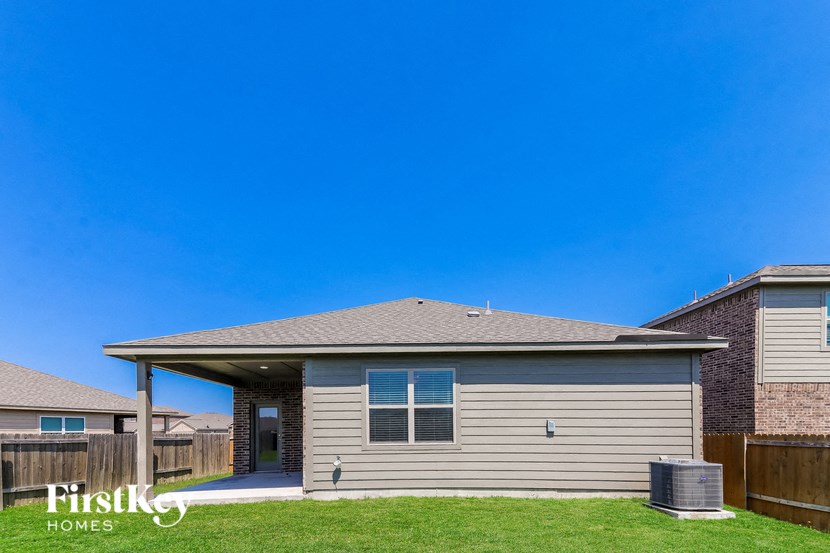 a tan house with a porch and a blue sky