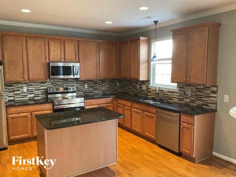 a kitchen with stainless steel appliances and wooden cabinets
