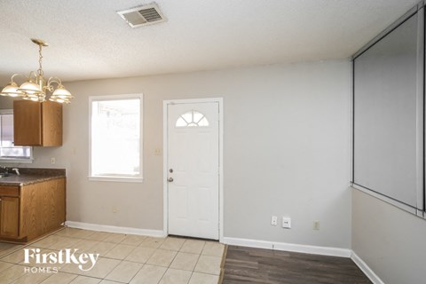 a kitchen with a white door and a refrigerator and a sink