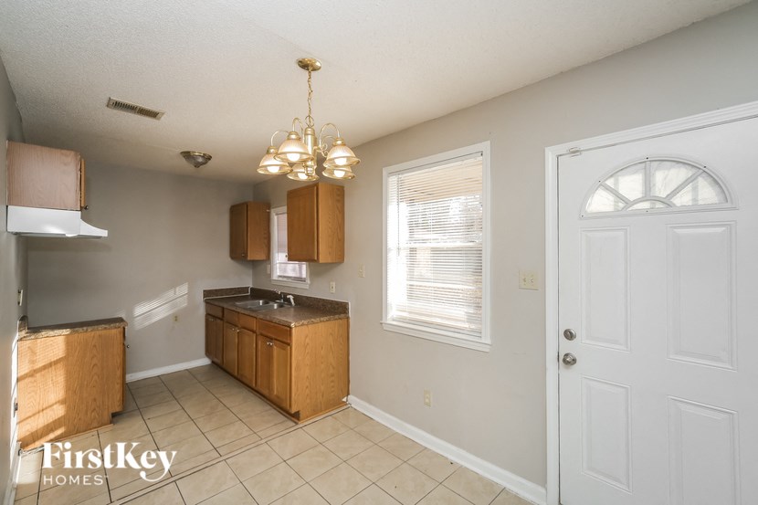 a kitchen with wooden cabinets and a white door