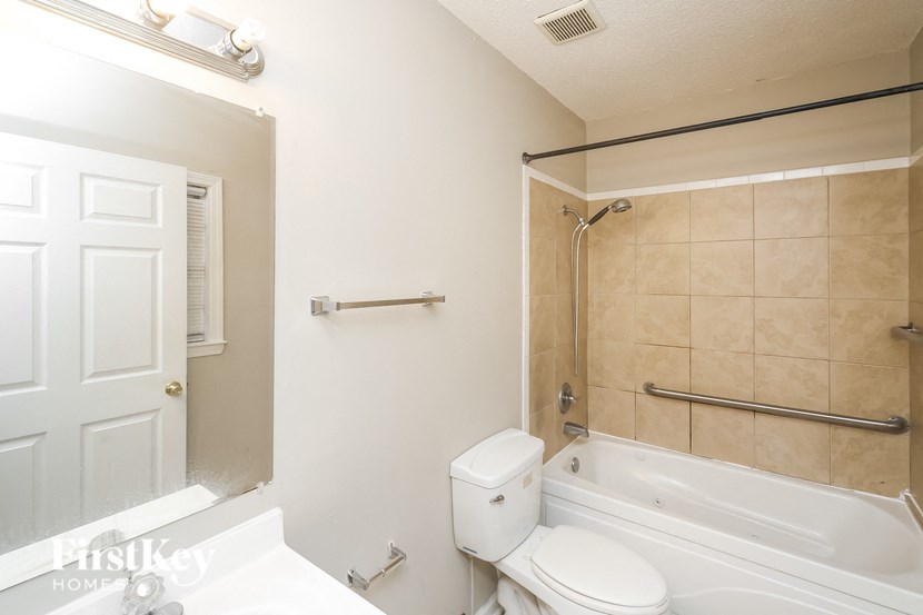 a bathroom with a tub and a toilet and a sink