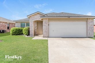 a home with a garage door and a lawn