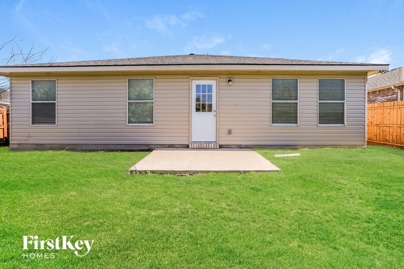 the front of a house with a yard and grass