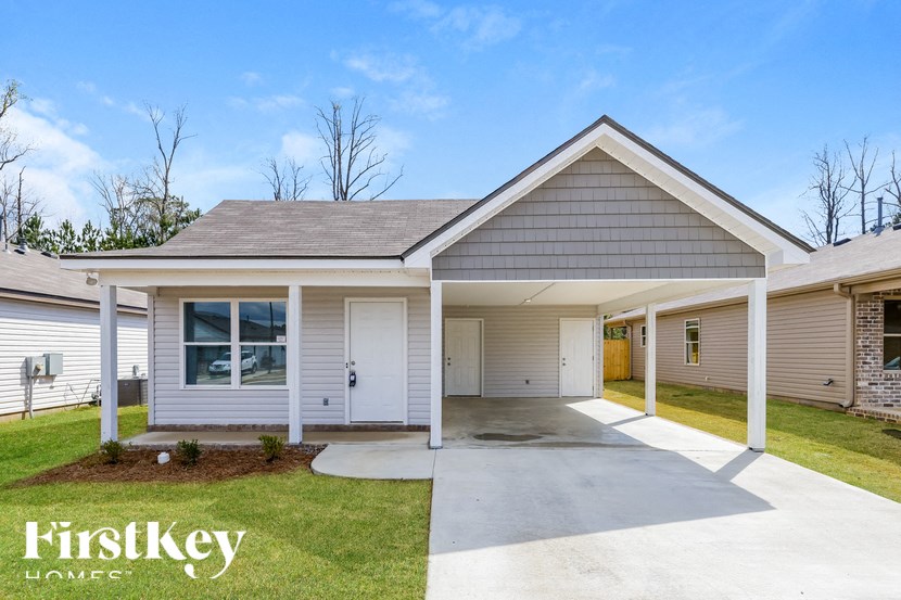 A house with a garage and a driveway is for sale.